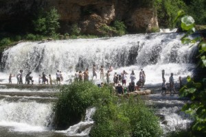 People wading in the falls
