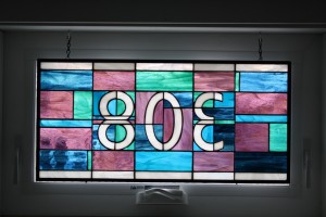 Custom stained glass panel in the transom over the front door.