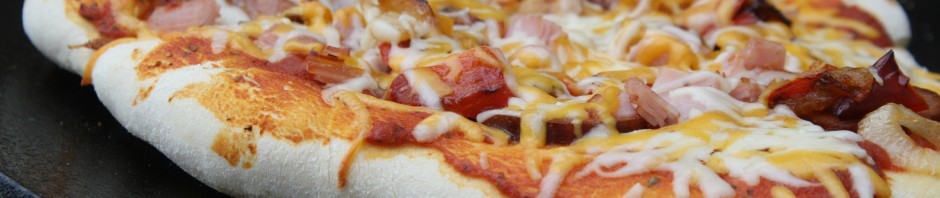 Dutch Oven Lid Pizza cooked on a Charcoal Grill